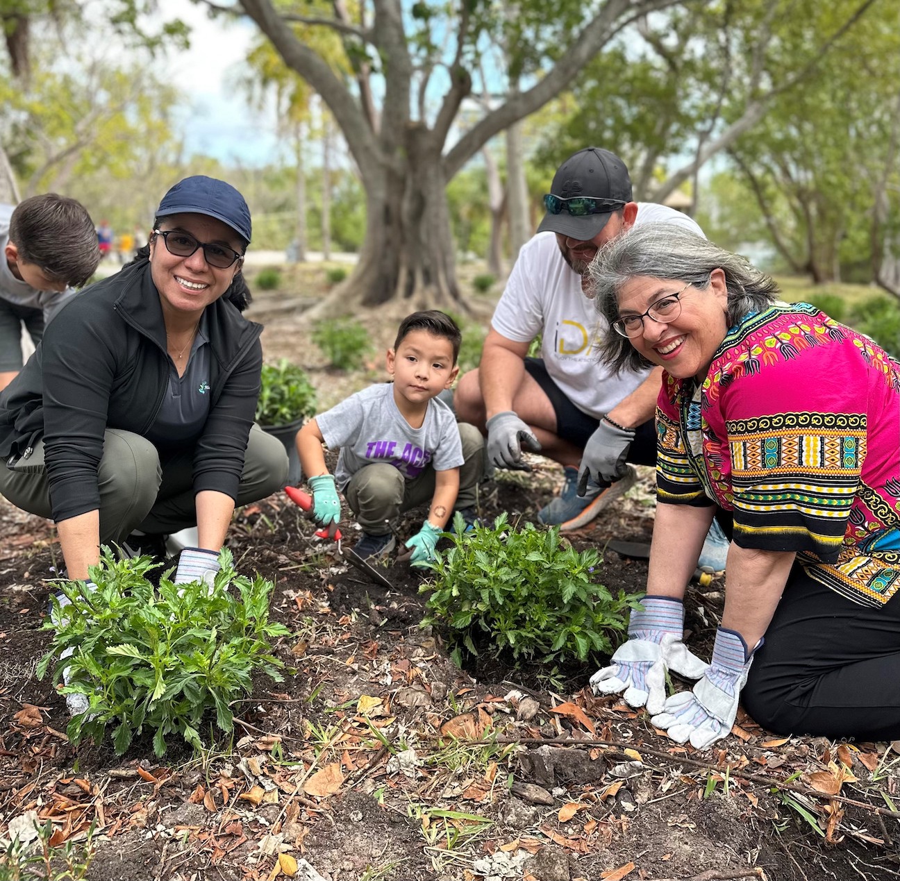 People planting trees and smiling in Miami