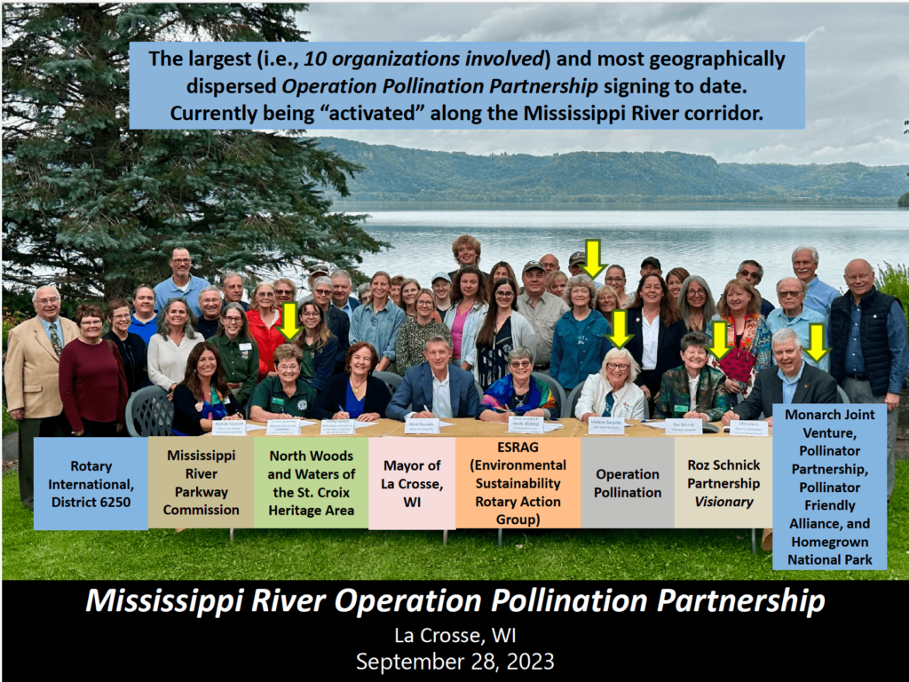 Group of people, representing the Mississippi River Operation Pollination Partnership, in front of river.