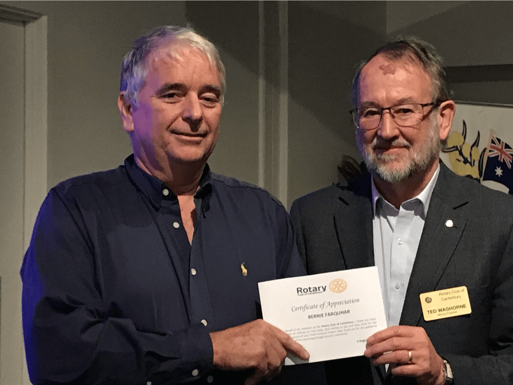 Two men holding Rotary's certificate of appreciation.