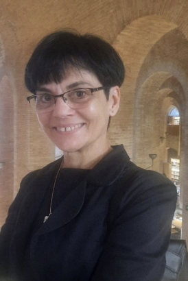 Headshot of woman with short black hair and glasses.