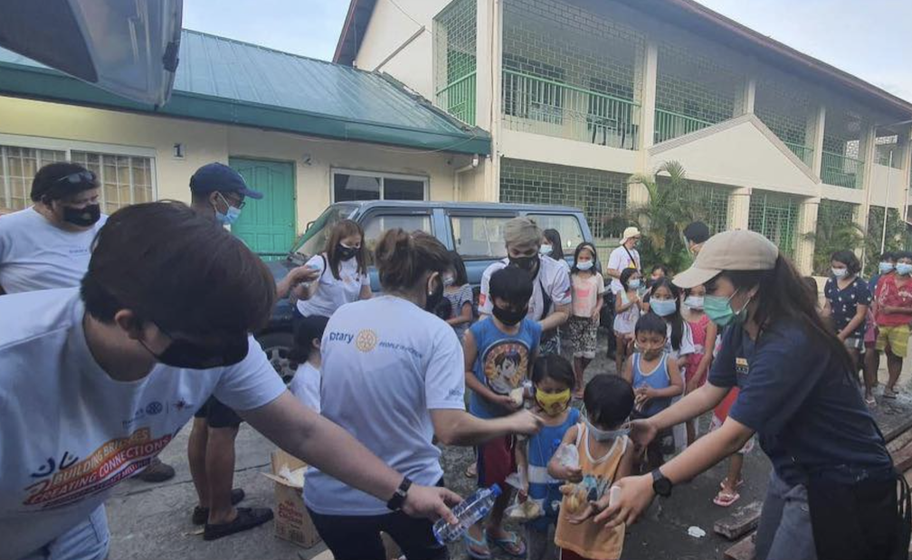 Group of people receiving relief goods following the typhoons.