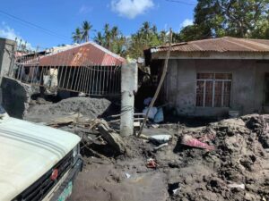 Damaged houses and muddy streets following the typhoon.
